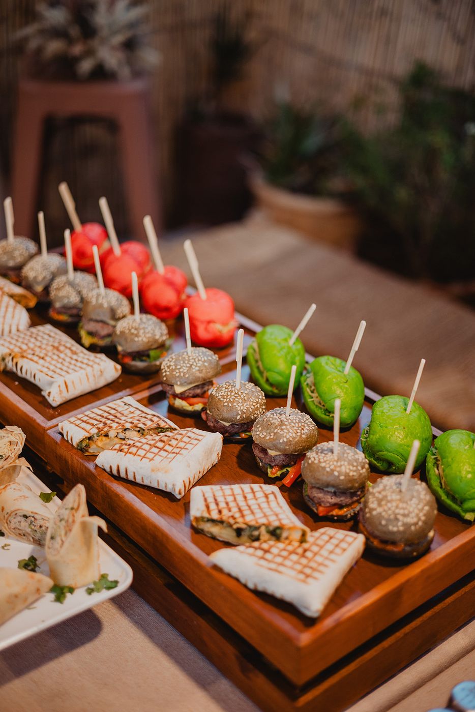 Mini burgers and bites on a wooden board