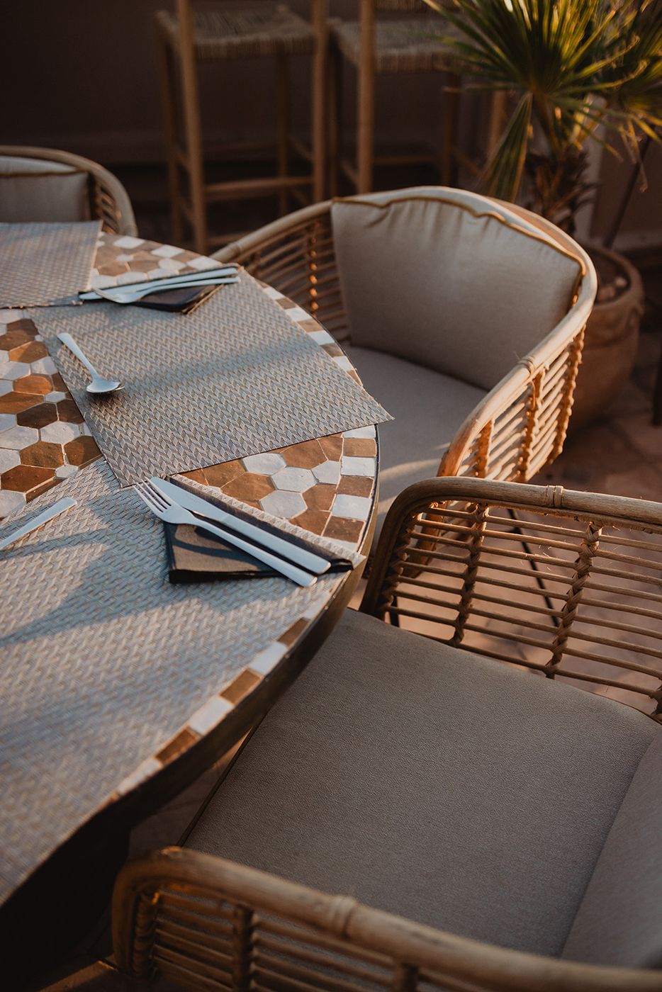 Round zellige table and rattan armchairs